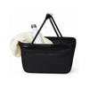A black shopper bag with a white drink bottle and a cream blanket inside. The bag features a logo on it.