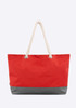 A red and grey tote bag with a rope handle and a simple design, featuring a logo.