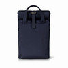 A navy blue Metro Backpack with a roll-top design and a strap. It features a branding logo on the front.