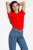 A model poses in a red short sleeve fine jersey crew tee paired with high-waisted blue jeans.
