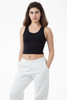 A black 2x1 rib crop tank top paired with white sweatpants, featuring a logo.