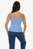 A fitted baby rib spaghetti tank top in light blue, displayed on a model with long hair, paired with denim jeans.