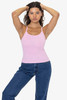 A pink baby rib spaghetti tank top worn by a model, featuring a fitted design and thin straps.