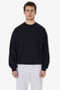 A black heavy fleece pullover sweater worn by a model, paired with light grey bottoms. It features a logo.