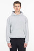 A grey mineral wash heavy fleece hooded pullover with a front pocket. The model stands with a neutral expression.
