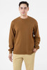 A brown heavy thermal crewneck sweater worn by a model, featuring a relaxed fit and long sleeves.