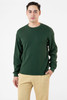 A man wearing a dark green heavy thermal crewneck jumper paired with beige trousers, featuring long sleeves.