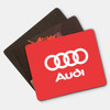 A set of three mouse mats in various colours, including a red one with a logo and two in darker tones.