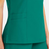 A green mock wrap top featuring pockets on the side, designed for women's wear, with a logo present.