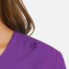 A purple women's mock wrap top featuring a neckline detail and a subtle logo.
