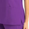A purple mock wrap top featuring a pocket and a side slit detail. The fabric appears smooth and lightweight.