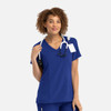 A women's mock wrap top in royal blue, featuring a v-neckline and a stethoscope around the neck.