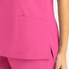 A pink women's mock wrap top featuring a side pocket and a stylish cut. The fabric appears smooth and lightweight.