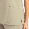 A women's mock wrap top in a light beige colour, featuring a side pocket and a sleek design.