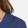 A navy women's mock wrap top with a decorative loop detail on the shoulder.