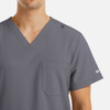 A grey V-neck top with four pockets and a logo, designed for men's wear.