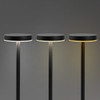 Three black rechargeable table lamps with round tops and adjustable light settings against a grey background.