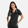 A woman wearing a black double V-neck top with a stethoscope around her neck, smiling, with pockets.
