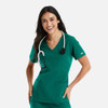 A woman wearing a green double V-neck top with stethoscope around her neck, featuring two front pockets.