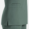 A women's double V-neck top in a soft green colour, featuring pockets and side slits for comfort. It has a logo.