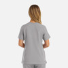 A women's double V-neck top in grey, featuring short sleeves and a relaxed fit, with a logo on the back.
