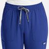 A pair of women's pull-on pants in vibrant blue with an elastic waistband and side pockets. Features a branding logo.
