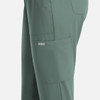A pair of women's full elastic pull-on pants in a muted green colour, featuring side pockets and a logo.