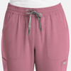 A pair of women's full elastic pull-on pants in a soft pink colour, featuring front pockets and a drawstring waist.