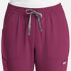 A pair of women's full elastic pull-on pants in a rich burgundy colour, featuring pockets and a drawstring.