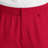 Red cargo pants featuring a fly front, elastic waistband, and a button closure. Includes a logo detail.