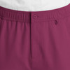 A close-up of men's cargo pants in a deep burgundy colour with a fly front and button detail.