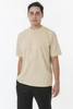 A short sleeve crewneck tee in beige, featuring a relaxed fit and a simple design, shown on a model.