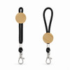 A keytag with a round wooden accent and a black rope strap, featuring a metal clasp for attachment.