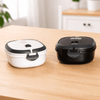A lunch box set featuring a black and a white container, both with secure lids and separate compartments.