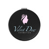 A round black compact mirror featuring a logo with a profile silhouette and "Velvet Dew Cosmetics" text.