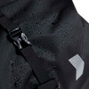A black waterproof duffle bag with a buckle closure, featuring a textured surface and droplets of water.