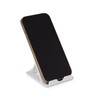 A phone in a white Glide Phone Stand, featuring a simple design with an adjustable angle.