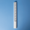 A white 30cm popper ruler featuring multiple poppers along its length, set against a blue background.