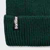 A dark green beanie with a knitted texture and a small black logo label.