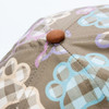 A cap featuring a textured pattern with colours including beige, purple, blue, and brown. It has a branding logo.