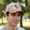 A cap featuring a full-colour patch, with a brown base and a patterned design in pastel colours.