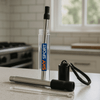 A telescopic stainless steel straw in a clear case, featuring a black cap and cleaning brush, with a branding logo.