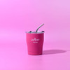A drink bottle in vibrant pink with a clear lid and straw, featuring a logo on the front.