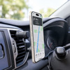 A car phone holder in black mounted on a dashboard air vent, displaying a smartphone with navigation.