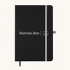 A black A5 notebook with an elastic closure and a logo on the front, featuring a grey band and bookmark.