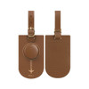A brown leather luggage tag with a circular attachment and a strap, featuring a logo.