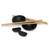A sushi set featuring black ceramic plates, wooden chopsticks, and small dipping bowls.