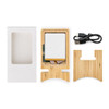A bamboo charging stand with a white charging pad, USB cable, and packaging box, all neatly arranged.