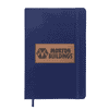 A navy blue A5 notebook with a textured cover and an embossed logo patch. It includes an elastic band closure.