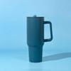 A drink bottle in teal with a handle and a lid, featuring a logo on the body.